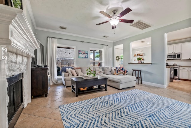 10010 Silverwood Way, Houston, TX 77070 - living room featuring light tile patterned floors, ceiling fan, ornamental molding, and a fireplace
