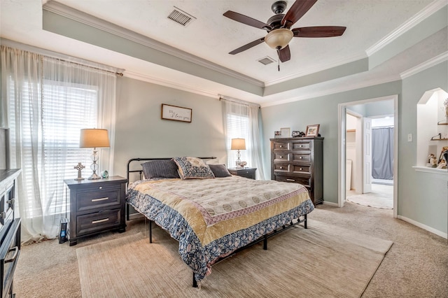 10010 Silverwood Way, Houston, TX 77070 - bedroom featuring a raised ceiling, light colored carpet, crown molding, a ceiling fan, and baseboards