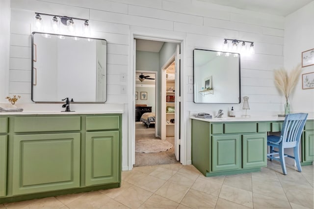 10010 Silverwood Way, Houston, TX 77070 - ensuite bathroom with two vanities, a ceiling fan, tile patterned floors, and wooden walls