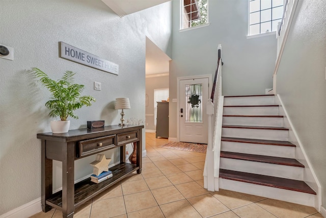 10010 Silverwood Way, Houston, TX 77070 - staircase featuring tile patterned flooring, baseboards, and a towering ceiling