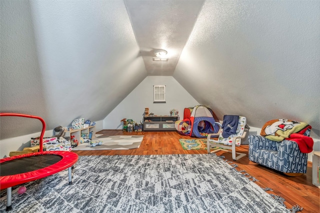10010 Silverwood Way, Houston, TX 77070 - game room with vaulted ceiling, wood finished floors, and a textured ceiling