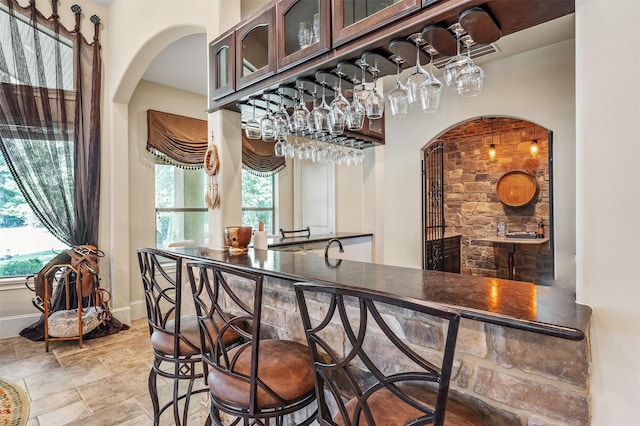 27309 S Lazy Meadow Way, Spring, TX 77386 - indoor bar with arched walkways, baseboards, and stone finish flooring