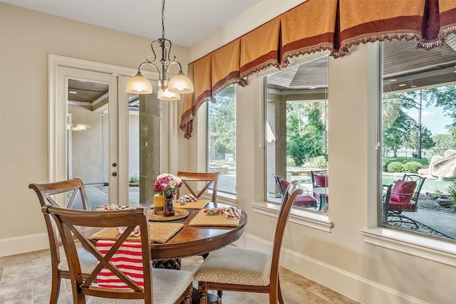 27309 S Lazy Meadow Way, Spring, TX 77386 - dining room with a chandelier, baseboards, and light stone finish flooring