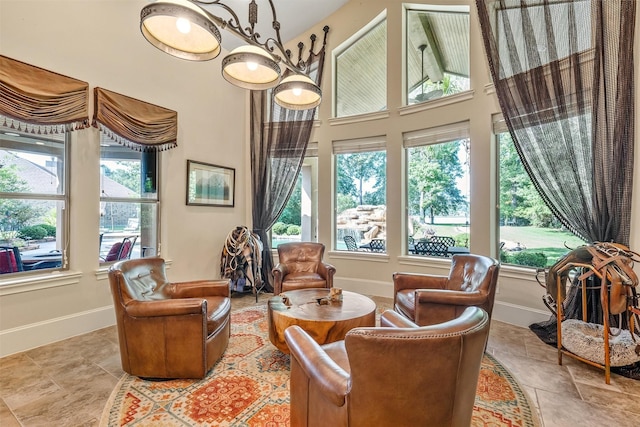 27309 S Lazy Meadow Way, Spring, TX 77386 - living area with healthy amount of natural light, baseboards, a high ceiling, and stone finish flooring