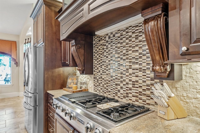 27309 S Lazy Meadow Way, Spring, TX 77386 - kitchen featuring appliances with stainless steel finishes, tasteful backsplash, plenty of natural light, and light stone counters
