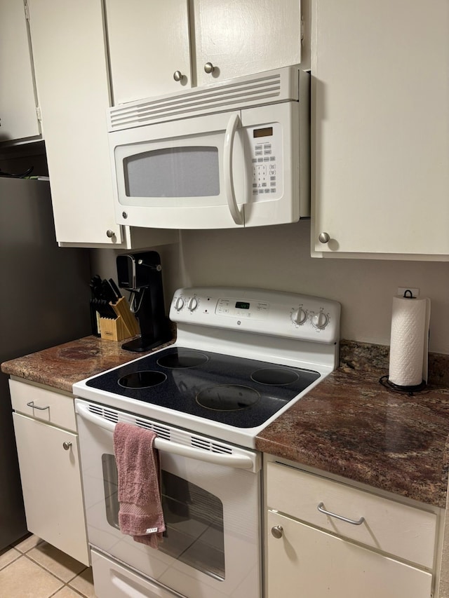 7950 N Stadium Dr Unit 132, Houston, TX 77030 - kitchen with white appliances, white cabinetry, and light tile patterned floors