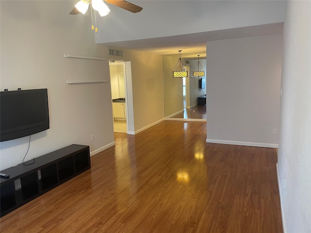 7950 N Stadium Dr Unit 132, Houston, TX 77030 - unfurnished living room featuring a ceiling fan, wood finished floors, and baseboards