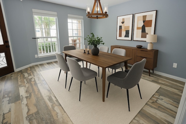 8611 Riverbend Canyon Ln, Houston, TX 77089 - dining room featuring a chandelier, healthy amount of natural light, baseboards, and wood finished floors