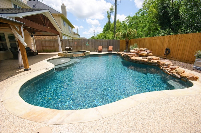 8611 Riverbend Canyon Ln, Houston, TX 77089 - view of swimming pool with a fenced backyard, ceiling fan, a patio area, and a pool with connected hot tub
