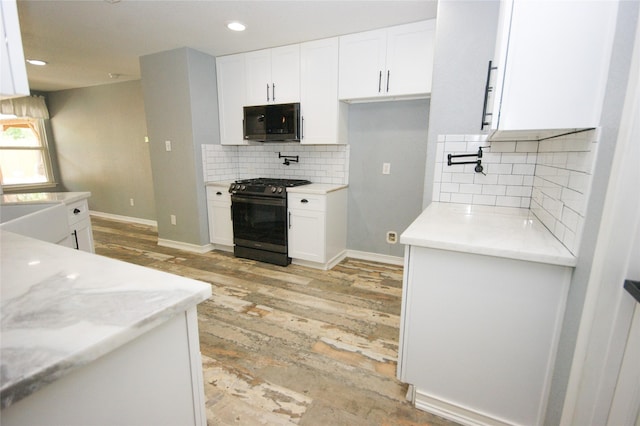8611 Riverbend Canyon Ln, Houston, TX 77089 - kitchen featuring black range with gas stovetop, light wood-style floors, white cabinets, backsplash, and recessed lighting