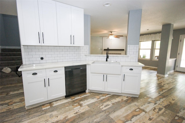 8611 Riverbend Canyon Ln, Houston, TX 77089 - kitchen with dishwashing machine, a sink, decorative backsplash, light countertops, and white cabinetry