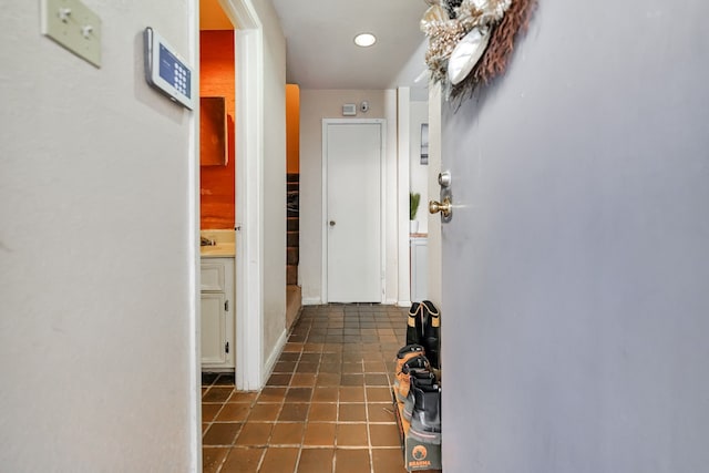 9090 S Braeswood Blvd Unit 107, Houston, TX 77074 - hallway with dark tile patterned flooring and recessed lighting