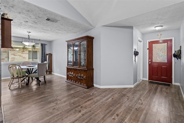 20074 Crazy Horse Circle Dr, Katy, TX 77449 - foyer entrance with a textured ceiling, wood finished floors, and baseboards