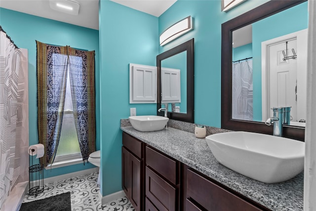 20074 Crazy Horse Circle Dr, Katy, TX 77449 - bathroom featuring double vanity, toilet, baseboards, and tile patterned flooring
