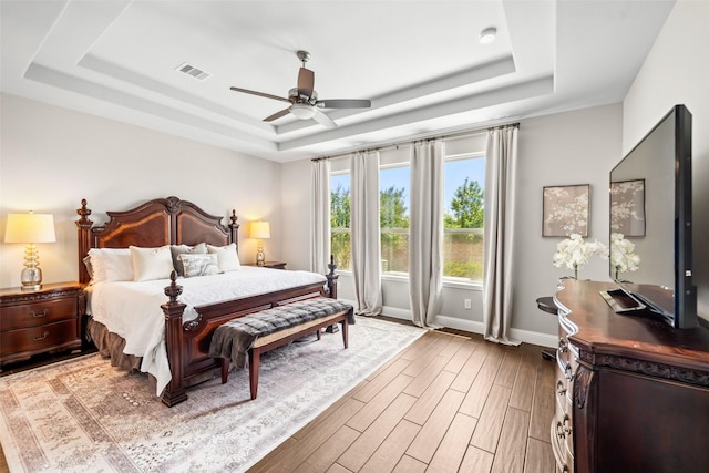 20511 Grazing Foal Ln, Tomball, TX 77377 - bedroom with a raised ceiling, wood finished floors, baseboards, and a ceiling fan