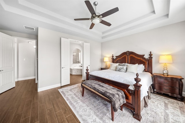 20511 Grazing Foal Ln, Tomball, TX 77377 - bedroom with a tray ceiling, baseboards, dark wood finished floors, connected bathroom, and a ceiling fan