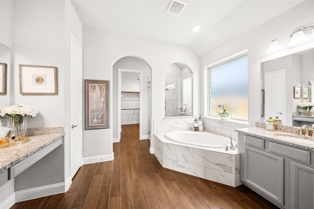 20511 Grazing Foal Ln, Tomball, TX 77377 - full bath with a garden tub, wood finished floors, vanity, a spacious closet, and baseboards