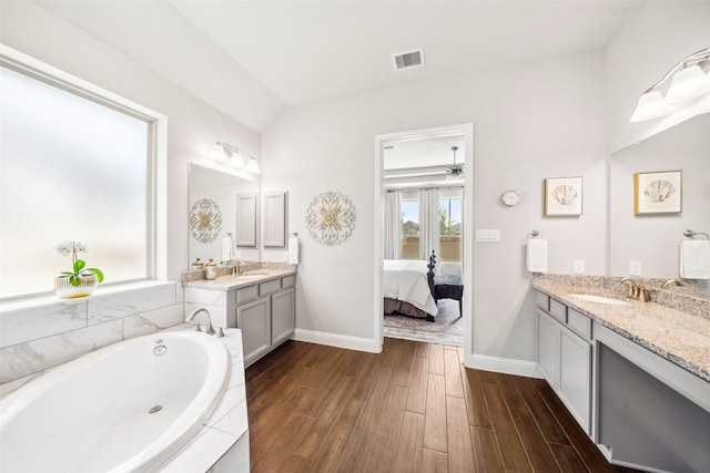 20511 Grazing Foal Ln, Tomball, TX 77377 - ensuite bathroom featuring two vanities, wood finished floors, a garden tub, and baseboards