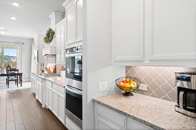 20511 Grazing Foal Ln, Tomball, TX 77377 - kitchen with appliances with stainless steel finishes, tasteful backsplash, white cabinets, recessed lighting, and dark wood-style flooring