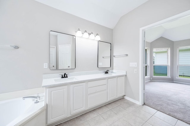 2604 Sunday House Ct, Pearland, TX 77584 - full bathroom featuring lofted ceiling, double vanity, tile patterned floors, and a tub to relax in