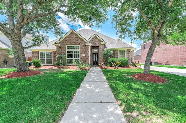 2604 Sunday House Ct, Pearland, TX 77584 - traditional home with brick siding, a front lawn, a shingled roof, and central air condition unit