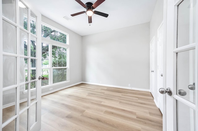 2604 Sunday House Ct, Pearland, TX 77584 - empty room with light wood-style floors, baseboards, a ceiling fan, and french doors