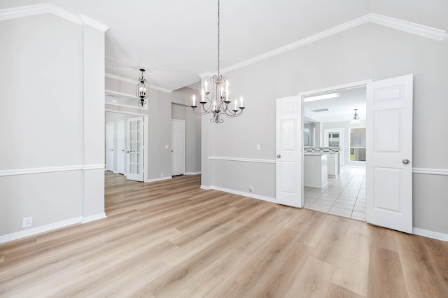 2604 Sunday House Ct, Pearland, TX 77584 - unfurnished dining area with a chandelier, vaulted ceiling, baseboards, light wood finished floors, and crown molding