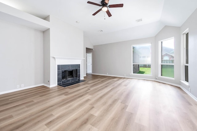 2604 Sunday House Ct, Pearland, TX 77584 - unfurnished living room with vaulted ceiling, ceiling fan, wood finished floors, a tile fireplace, and baseboards