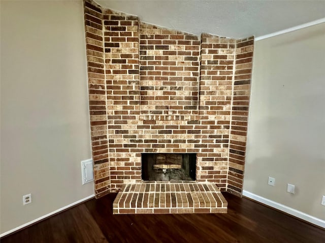 3611 Acorn Way Ln, Spring, TX 77389 - detailed view of wood finished floors, baseboards, and a fireplace