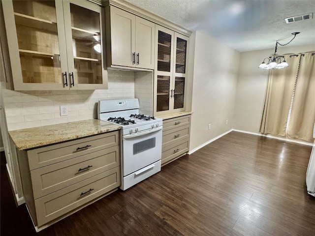 3611 Acorn Way Ln, Spring, TX 77389 - kitchen featuring white range with gas stovetop, backsplash, dark wood-style flooring, baseboards, and a textured ceiling