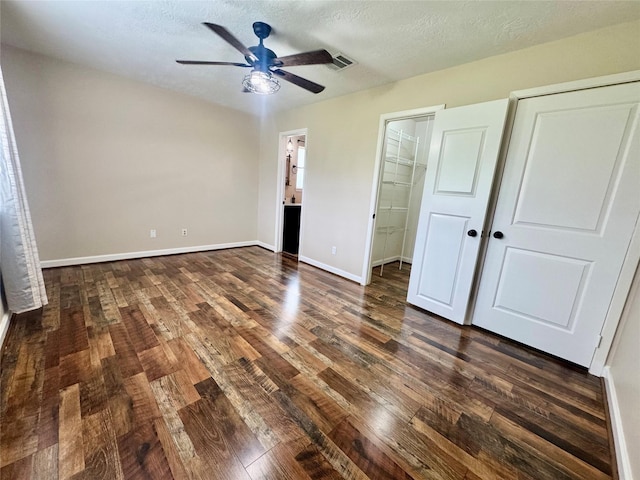 3611 Acorn Way Ln, Spring, TX 77389 - unfurnished bedroom with dark wood finished floors, baseboards, ensuite bathroom, a textured ceiling, and a ceiling fan