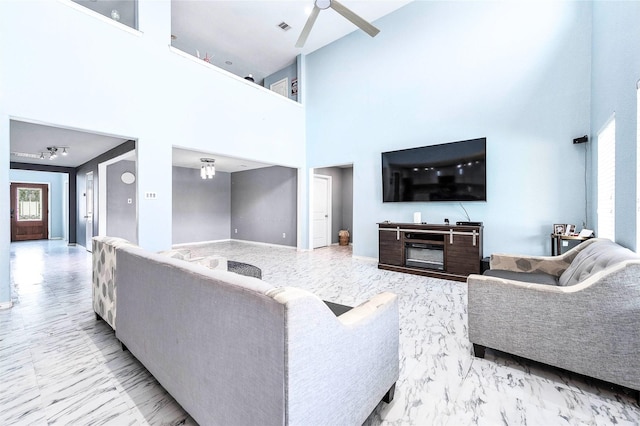 18110 Tenasserim Pine Trce, Richmond, TX 77407 - living room with a high ceiling, ceiling fan, marble finish flooring, and baseboards