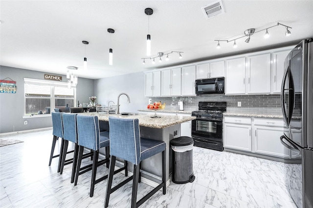 18110 Tenasserim Pine Trce, Richmond, TX 77407 - kitchen featuring black appliances, a sink, white cabinets, and tasteful backsplash