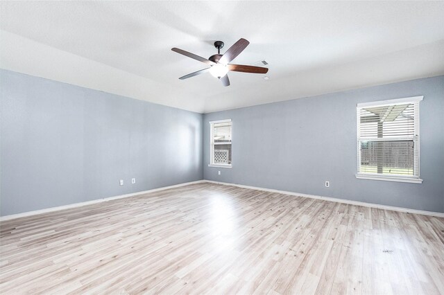 18110 Tenasserim Pine Trce, Richmond, TX 77407 - empty room featuring light wood-style floors, ceiling fan, and baseboards
