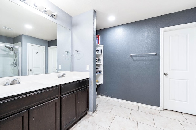 18110 Tenasserim Pine Trce, Richmond, TX 77407 - bathroom featuring double vanity, a stall shower, tile patterned flooring, baseboards, and a textured wall