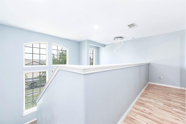 18110 Tenasserim Pine Trce, Richmond, TX 77407 - hallway with baseboards, wood finished floors, and an upstairs landing