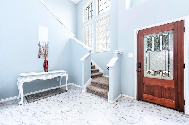 18110 Tenasserim Pine Trce, Richmond, TX 77407 - foyer featuring marble look tiles, healthy amount of natural light, stairs, baseboards, and a high ceiling