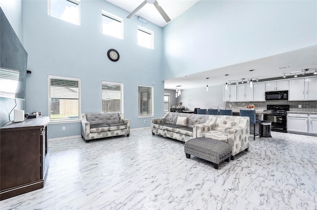 18110 Tenasserim Pine Trce, Richmond, TX 77407 - living area featuring a high ceiling, baseboards, and light marble finish flooring