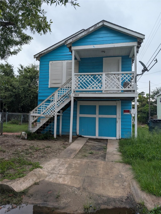 1912 52nd St, Galveston, TX 77551 - view of front facade with stairs and driveway