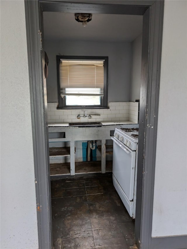 1912 52nd St, Galveston, TX 77551 - kitchen featuring white gas range oven and backsplash