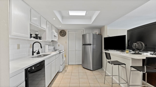 14777 Wunderlich Dr Unit 2013, Houston, TX 77069 - kitchen featuring white appliances, a sink, light countertops, decorative backsplash, and white cabinetry
