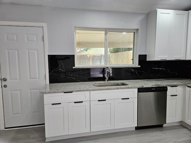 21631 Park Villa Dr, Katy, TX 77450 - kitchen with dishwasher, a sink, light stone countertops, tasteful backsplash, and white cabinets