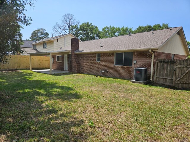 21631 Park Villa Dr, Katy, TX 77450 - rear view of property featuring brick siding, a patio, a shingled roof, and central AC unit