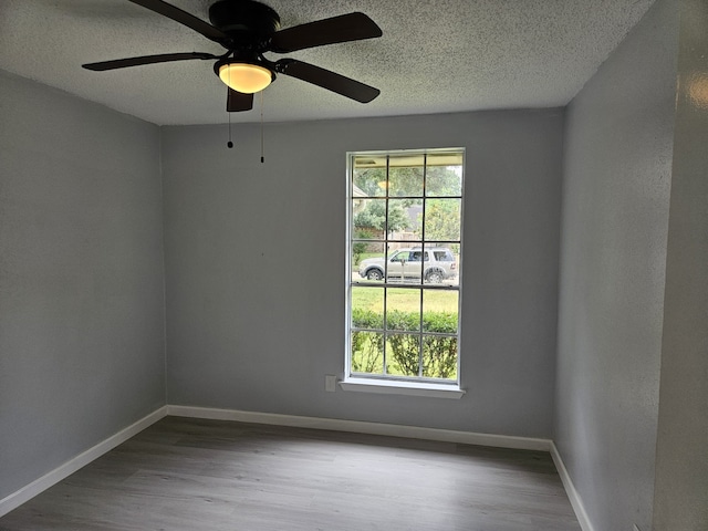 21631 Park Villa Dr, Katy, TX 77450 - unfurnished room with a textured ceiling, wood finished floors, baseboards, and a ceiling fan