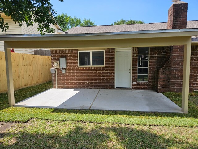 21631 Park Villa Dr, Katy, TX 77450 - back of property with a chimney, brick siding, and a patio area