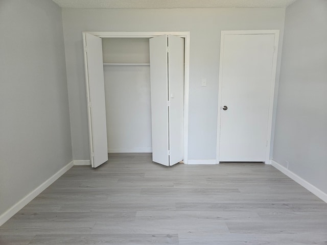 21631 Park Villa Dr, Katy, TX 77450 - unfurnished bedroom with a closet, baseboards, and light wood-style floors