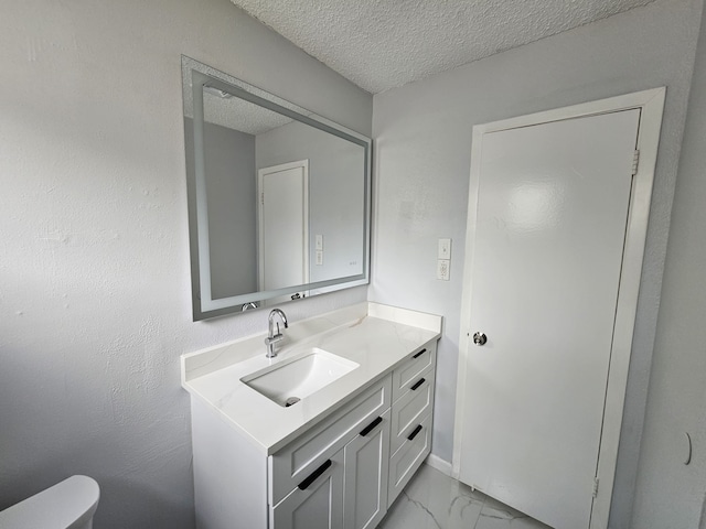 21631 Park Villa Dr, Katy, TX 77450 - half bath with marble look tile flooring, vanity, a textured ceiling, and toilet