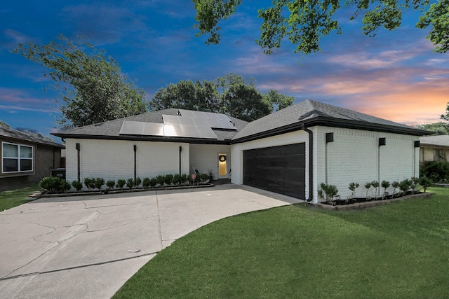 3707 Kingston Vale Dr, Houston, TX 77082 - view of front facade with brick siding, a garage, concrete driveway, a lawn, and roof mounted solar panels