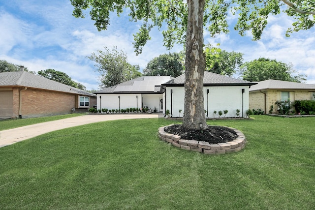 3707 Kingston Vale Dr, Houston, TX 77082 - view of front facade featuring roof mounted solar panels, a front lawn, driveway, and brick siding