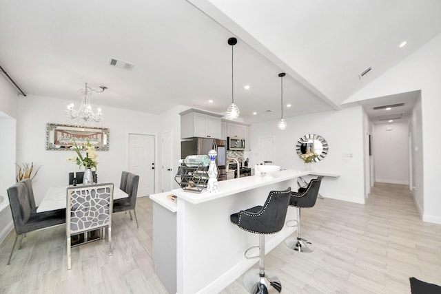 3707 Kingston Vale Dr, Houston, TX 77082 - kitchen with appliances with stainless steel finishes, light countertops, recessed lighting, a kitchen breakfast bar, and a chandelier